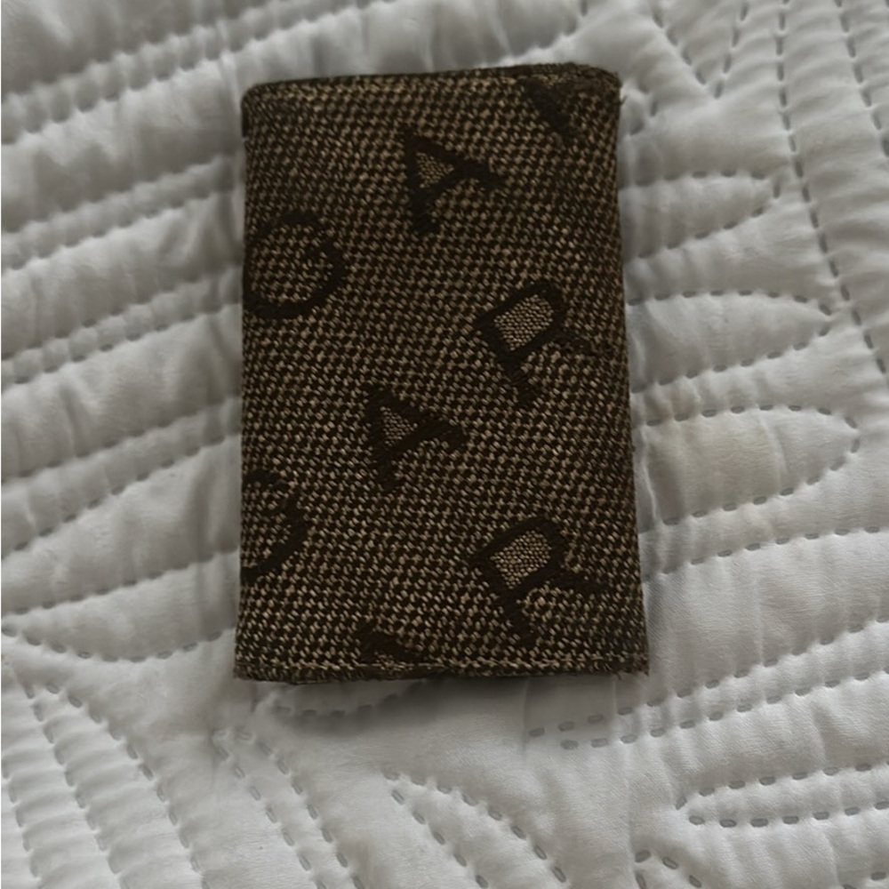 Bvlgari key holder featuring the brand's logo pattern on canvas.